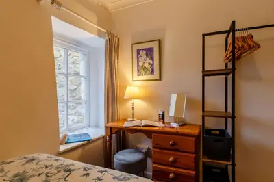 a bedroom with a desk and a bed and a window at 2 Bed in Two Waters Foot oc-s27334 in Warleggan