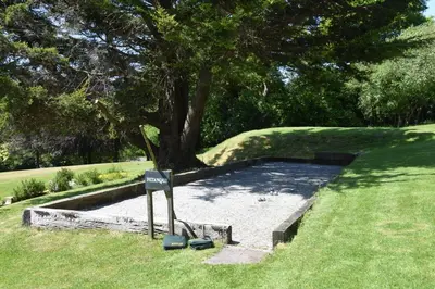 a park with a tree and a sign in the grass at 2 Bed in Two Waters Foot oc-s27334 in Warleggan