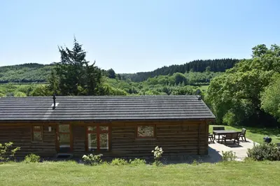 a log cabin with a picnic table in front of it at 3 Bed in Two Waters Foot oc-m27335 in Cardinham