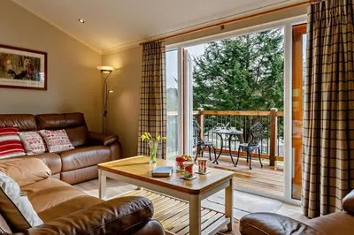 a living room with a couch and a table at 3 Bed in Two Waters Foot oc-m27335 in Cardinham
