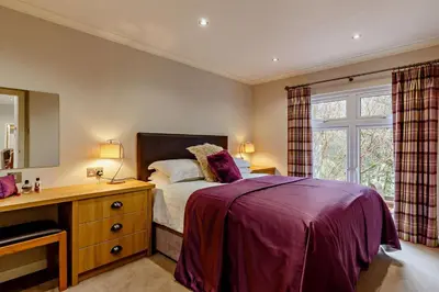 a bedroom with a bed and a desk and a window at 3 Bed in Two Waters Foot oc-r27336 in Cardinham