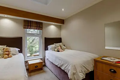 a bedroom with two beds and a window at 3 Bed in Two Waters Foot oc-r27336 in Cardinham