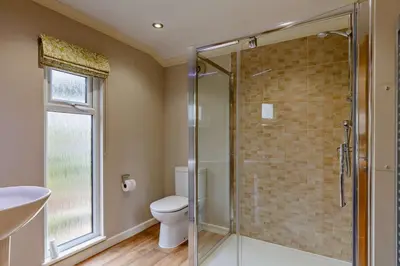 a bathroom with a toilet and a glass shower at 3 Bed in Two Waters Foot oc-r27336 in Cardinham