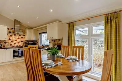a kitchen with a wooden table with chairs and a dining room at 3 Bed in Two Waters Foot oc-r27336 in Cardinham