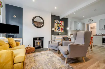 a living room with a couch and chairs and a fireplace at 3 Bed in Fowey oc-g33050 in Fowey