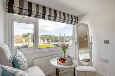 a living room with a window and a bowl of fruit on a table at 3 Bed in Fowey oc-g33050 in Fowey