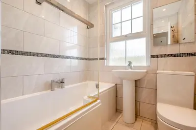 a bathroom with a sink and a tub and a toilet at 3 Bed in Fowey oc-g33050 in Fowey