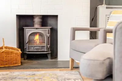 a fireplace in a living room with a stove at 3 Bed in Fowey oc-g33050 in Fowey