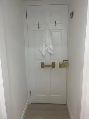 a white door with a towel hanging on it at Central loft apartment sea views in Falmouth