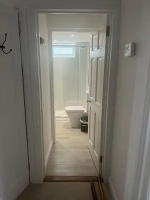 a hallway leading to a bathroom with a toilet at Central loft apartment sea views in Falmouth