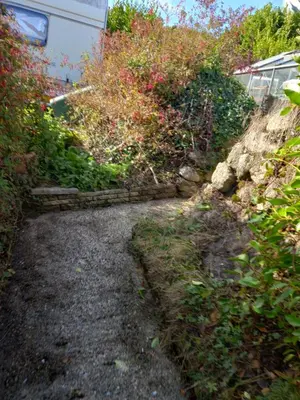 a path in a garden next to some bushes at Garden room in St Ives