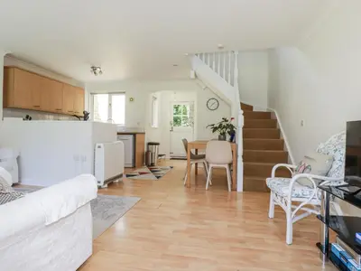 a living room with a couch and a table at Acorns in Falmouth