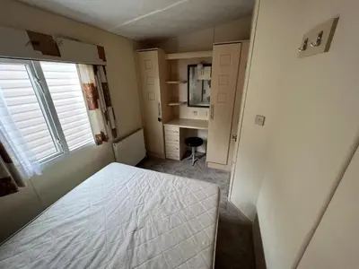 a bedroom with a bed and a desk and a window at Riverdale in Saint Clether