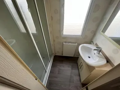 a small bathroom with a sink and a shower at Riverdale in Saint Clether