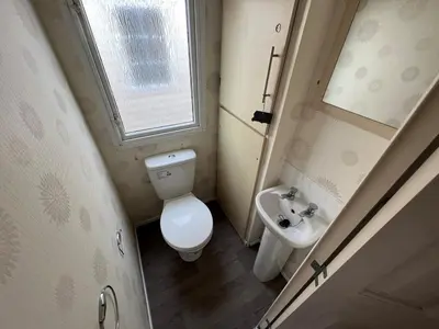 a small bathroom with a toilet and a sink at Riverdale in Saint Clether
