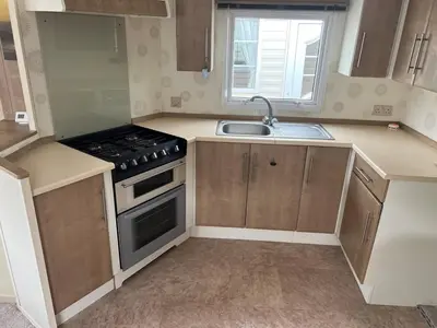 a small kitchen with a stove and a sink at Riverdale in Saint Clether