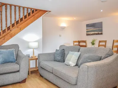 a living room with a couch and two chairs at Norvys in Tintagel