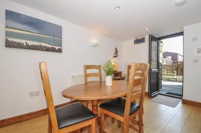 a dining room with a wooden table and chairs at Norvys in Tintagel