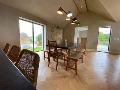 a dining room with a table and chairs at Parc an Praze - Cornwall Retreat by the Sea in Perranuthnoe