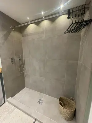 a bathroom with a shower with a basket at Parc an Praze - Cornwall Retreat by the Sea in Perranuthnoe