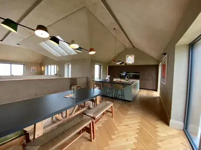 a dining room with a large black table and chairs at Parc an Praze - Cornwall Retreat by the Sea in Perranuthnoe