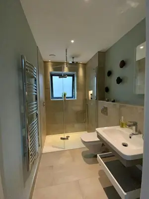 a bathroom with a shower and a toilet and a sink at Chymaen - Magnificent Cornish coastal home in Marazion