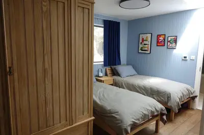 a bedroom with two twin beds and a window at Chymaen - Magnificent Cornish coastal home in Marazion