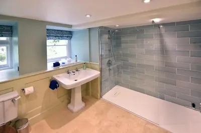 a bathroom with a sink and a shower at Historical Churchtown House Cornwall in Perranuthnoe