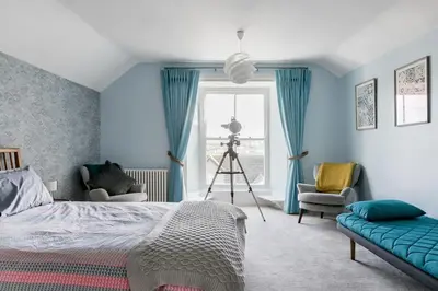a bedroom with a bed and a camera and a tripod at Grade II Listed 17th-Century Rectory in Cornwall in Perranuthnoe