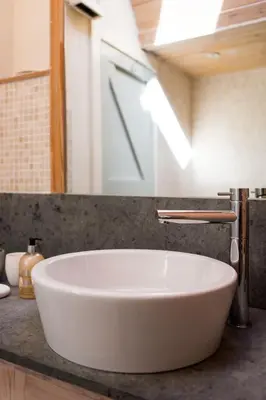 a white sink on a counter in a bathroom at Stunning Old Carthouse with seaview in Penzance