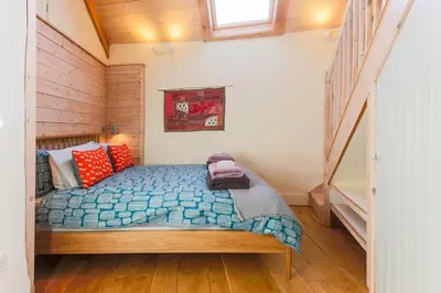 a bedroom with a bed in a house at Stunning Old Carthouse with seaview in Penzance