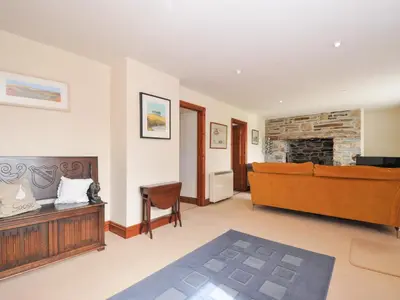 a living room with a couch and a fireplace at Rosewin Farmhouse in Wadebridge
