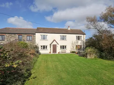 a large white house with a large yard at Rosewin Farmhouse in Wadebridge