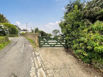 a gate on the side of a dirt road at Point House in Saint Just in Roseland