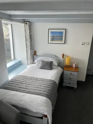 a bedroom with a large bed and a window at The Fourways Inn in Saint Minver