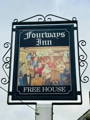 a sign for a fire house on the side of a building at The Fourways Inn in Saint Minver