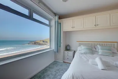 a bedroom with a bed with a view of the ocean at 2 Bed in St Ives oc-bpp03 in St Ives