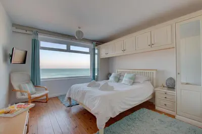 a bedroom with a bed with a view of the ocean at 2 Bed in St Ives oc-bpp03 in St Ives