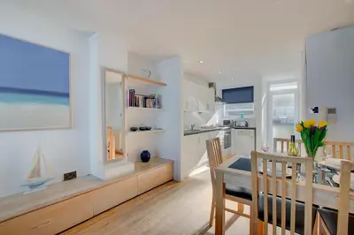 a kitchen and dining room with a table and a dining room at 2 Bed in St Ives oc-bpp03 in St Ives