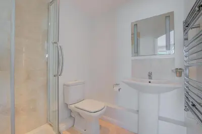 a white bathroom with a toilet and a sink at 2 Bed in St Ives oc-bpp03 in St Ives