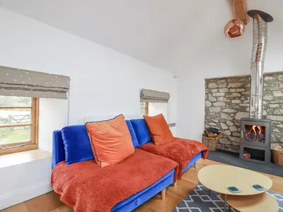 a living room with a couch and a fireplace at The Old Dairy in Bodmin
