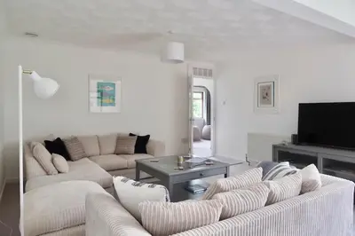 a living room with two couches and a tv at Sleeps 9- KingBeds- FamilyFriendly- ContactlessCI in Wadebridge
