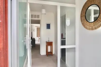 a hallway with a mirror on the wall and a door at Sleeps 9- KingBeds- FamilyFriendly- ContactlessCI in Wadebridge