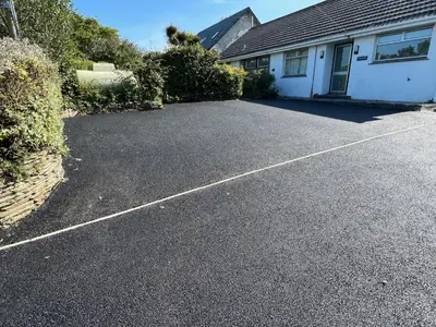a driveway in front of a white house at Sleeps 9- KingBeds- FamilyFriendly- ContactlessCI in Wadebridge