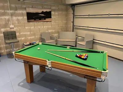 a room with a pool table and some chairs at Roughtor View in Camelford