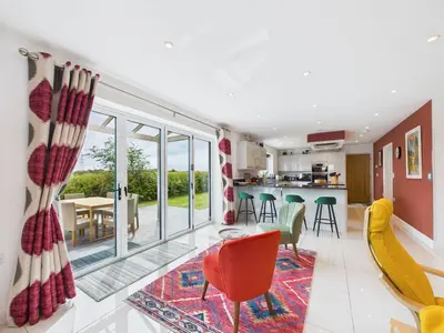 an open living room with a dining room and kitchen at Roughtor View in Camelford