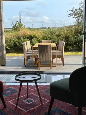 a dining table and chairs on a patio at Roughtor View in Camelford