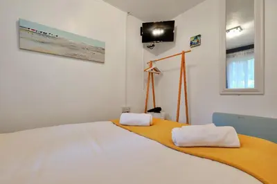 a bedroom with a bed with two towels on it at Finest Retreats - Joyful Cottage in St Ives