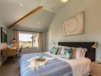 a bedroom with a large bed with a table on it at 5 Bed in Fowey oc-93849 in Polruan