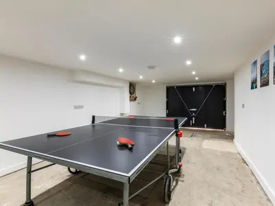 a ping pong table in the middle of a room at 5 Bed in Fowey oc-93849 in Polruan